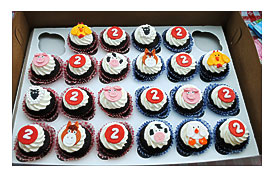 Few Chocolate Cupcakes In Red And Blue Gingham Wrappers With Fondant