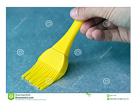 Applying Oil To Baking Parchment With Pastry Brush Royalty Free Stock