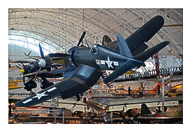 Steven F. Udvar Blurred Center Vought F4U 1D Corsair, with P 40 Warhawk in background