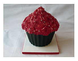 The Tower Is Topped With A Giant Chocolate Cupcake Sat In A Chocolate