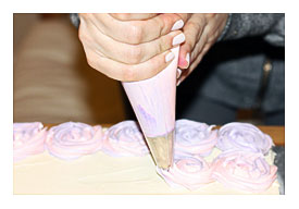 Used A 1M Open Star Tip To Pipe The Flowers Onto The Cake. For Each